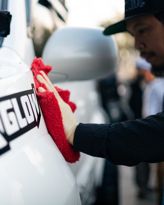 wiping down a car at car show with nextzett perfect shine detail spray and a microfiber towel